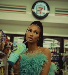 a woman in a feathery dress holding a drink