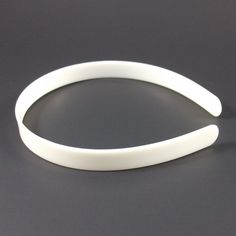 a white plastic bracelet on a black surface