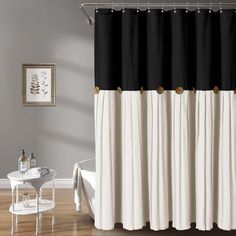 black and white shower curtain with gold trim on the bottom part, in a bathroom