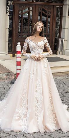 a woman in a wedding dress standing on the street