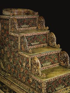 an elaborately decorated set of stairs in the shape of a staircase with intricate carvings