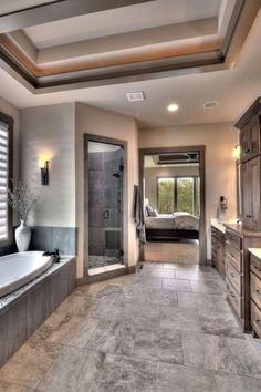 a large bathroom with a walk in shower next to a bathtub