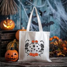 a trick or treat tote bag with jack - o'- lanterns and pumpkins