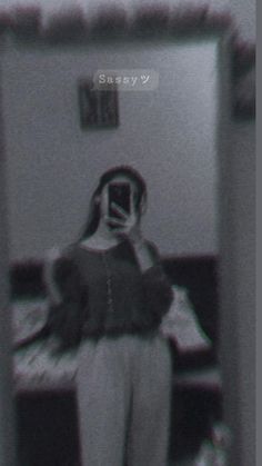 a woman standing in front of a mirror