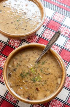 two bowls filled with soup sitting on top of a red and black checkered table cloth