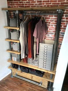 an industrial style closet with clothes and drawers