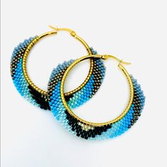 blue and black beaded hoop earrings on white background