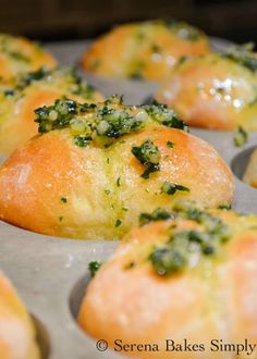 several muffins with broccoli and cheese on them in a baking pan