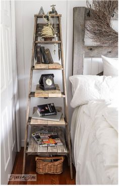 an old ladder is used as a shelf for books and magazines in the corner of this bedroom