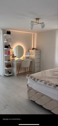 a bedroom with a bed, desk and mirror on the wall next to a window