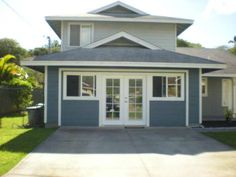 a blue house with white doors and windows