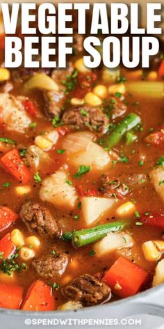 vegetable beef soup with corn and carrots in a pot