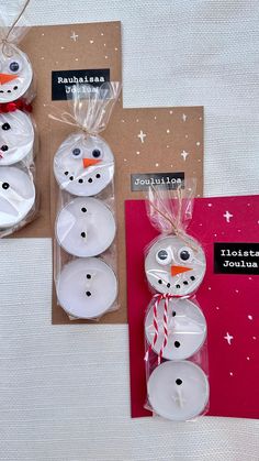 three snowmen made out of candles sitting on top of a table