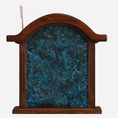 an old fashioned wooden clock with blue marble on it's front and back sides