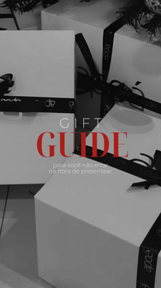 three white boxes with black bows on them and the words gift guide written in red