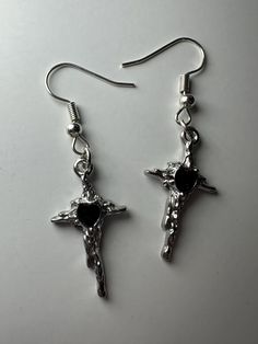 This handmade pair of earrings features a beautiful silver set of melted cross pendants. Perfect for everyday wear or special occasions! May not be best suited for water wear* Handmade Metal Cross Earrings, Silver Metal Cross Pendant Earrings, Metal Cross Pendant Earrings For Gift, Metal Cross Pendant Earrings As Gift, Silver Nickel-free Cross Pendant Earrings, Silver Cross Pendant Pierced Earrings, Silver Cross Pendant Earrings, Silver Cross Pendant Earrings, Nickel-free, Silver Cross Pendant Earrings, Nickel Free