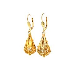 These Intricate Filigree Mid-Century Drop Earrings feature a vintage teardrop chandelier design 14 karat yellow gold. Royal filigree metalwork wears around each pear-shaped charm. Two seashell engravings decorate the front of the lever backings. A milgrain rope and openwork design. The drops measure 1.75 inches long and .25 inches wide. Romantic, radiant, and truly unique. French-inspired Mid-Century drops to lighten up your look! Yellow Gold Historical Drop Earrings, Historical Yellow Gold Drop Earrings, Yellow Gold Drop Earrings With Historical Design, Formal Yellow Gold Chandelier Earrings With Intricate Design, Formal Baroque Filigree Earrings, Formal Filigree Baroque Earrings, Ornate Bridal Earrings For Festive Occasions, Elegant Yellow Gold Earrings With Historical Design, Ornate Bridal Earrings For Formal Occasions