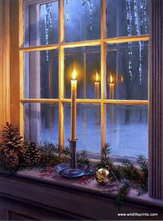 a lit candle sitting on top of a window sill in front of a snow covered window