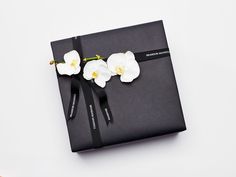 a black book with white flowers tied to it