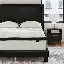 a black bed frame with white pillows in a modern bedroom setting on an area rug