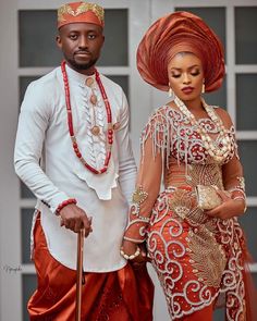 a man and woman dressed in traditional african garb