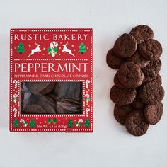 a box of chocolate cookies next to a pile of cookies