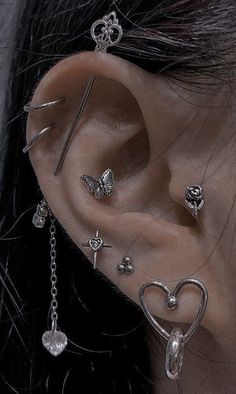 a woman with ear piercings and chains on her ears