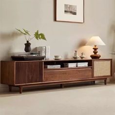 a living room with an entertainment center and two lamps on either side of the tv