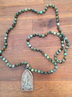 This African Turquoise Beaded Buddha Mala Necklace is exquisite quality!Handmade beaded African Turquoise prayer beads meditation necklace. This lovely pendant is made in Thailand from a mold patterned after an antique mold that has been used for making sacred amulets for over 500 years.  Beads are 6mm and the pendant is 2 inches long 1 inch wide. Adjustable Beaded Turquoise Necklace For Meditation, Adjustable Spiritual Turquoise Necklace For Meditation, Bohemian Beaded Turquoise Necklace For Meditation, Bohemian Turquoise Necklace With 108 Beads For Gift, Turquoise Spiritual Beads For Meditation, Spiritual Turquoise Beads For Meditation, Spiritual Turquoise Beaded Necklace With 108 Beads, Handmade Spiritual Turquoise Necklace With Round Beads, Spiritual Turquoise Necklace With Round Beads For Meditation