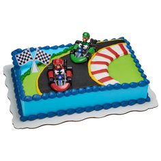 a birthday cake with an image of mario kart on the track and race cars