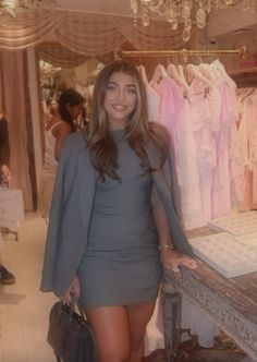 a woman standing next to a table in a store