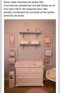 a baby's room with blue walls and white furniture