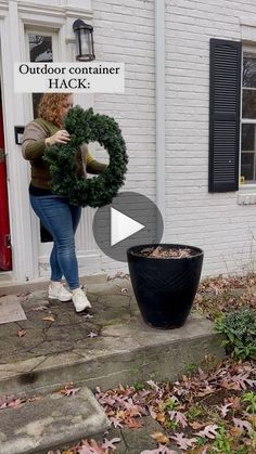 a woman holding a wreath in front of a house with the words outdoor container hack