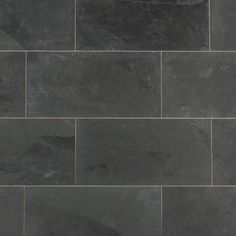 a black slate tile floor with grey veining