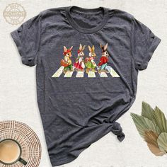 Walking Rabbit and Friends Shirt, Easter Bunny Cute Tshirt, Kids Easter Bunny Shirt, Funny Rabbit Women Outfit, Birthday Tee, Cute Bunny Tee. Welcome to BestMomentTees! Step into a world of comfort and style with our hand made shirts from the renowned Bella Canvas brand. The solid colors are 100% pure cotton, while the delightful heather colors are a charming blend of 52% cotton and 48% polyester. 🍃 Each shirt is a true labor of love, meticulously created using the innovative DTF printing metho Casual Tops With Cartoon Print For Birthdays, Casual Tops With Cartoon Print For Birthday, Casual Cartoon Print Tops For Birthday, Cute Crew Neck Easter Tops, Short Sleeve Cartoon Print Top As Gift, Short Sleeve Tops With Cartoon Print For Gift, Cartoon Print Short Sleeve Top For Gift, Casual Tops With Character Print For Gifts, Casual Character Print Top For Birthday