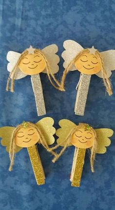 three little angel wands with gold glitter wings on blue paper and jumbo sticks