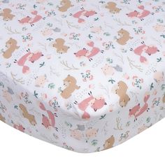 a white sheet with bears and deers on it's side, next to a pillow