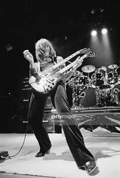 the runaways performing on stage with their electric guitars in front of them, during a concert