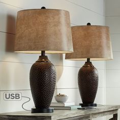 two lamps sitting on top of a wooden table