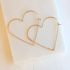 "Heart shaped hoops, lightweight and minimalist. Choose from three sizes and from sterling silver, 14k gold fill or rose gold fill. Super lightweight, you won't even know they are there. Small .75\" Medium 1.25\" Large 1.75\" Metal: Choose from sterling silver, 14k gold fill, rose gold fill Earring Replacements If you were to lose an earring, I will be happy to make a matching one for half price and free shipping! All orders come packaged ready for gift giving. In order to keep down on waste, or 75 Medium, Dainty Gold Earrings, Xmas Sale, Hoops Gold, Open Hoop Earrings, Heart Hoop Earrings, Friendship Necklaces, Earrings Bridesmaid, Earrings Geometric