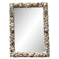 a mirror with shells and starfishs on it