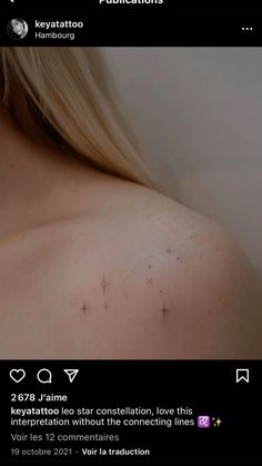 the back of a woman's shoulder with small stars on her left arm and chest