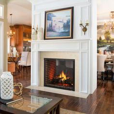 a living room filled with furniture and a fire place under a painting on the wall