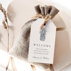 a welcome tag attached to a chair with burlap and twine on it