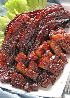 barbecue ribs on a white plate with lettuce