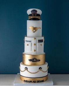 there is a three tiered cake with gold trimmings on the top and bottom