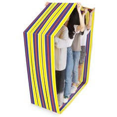 two girls are peeking out from behind a colorful striped paper box that is open to reveal the inside