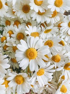 white and yellow flowers are in a vase