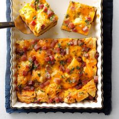 a casserole dish with ham and cheese on it next to a serving spoon