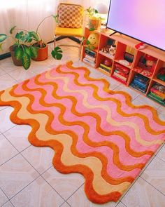 a living room with a large rug on the floor next to a flat screen tv